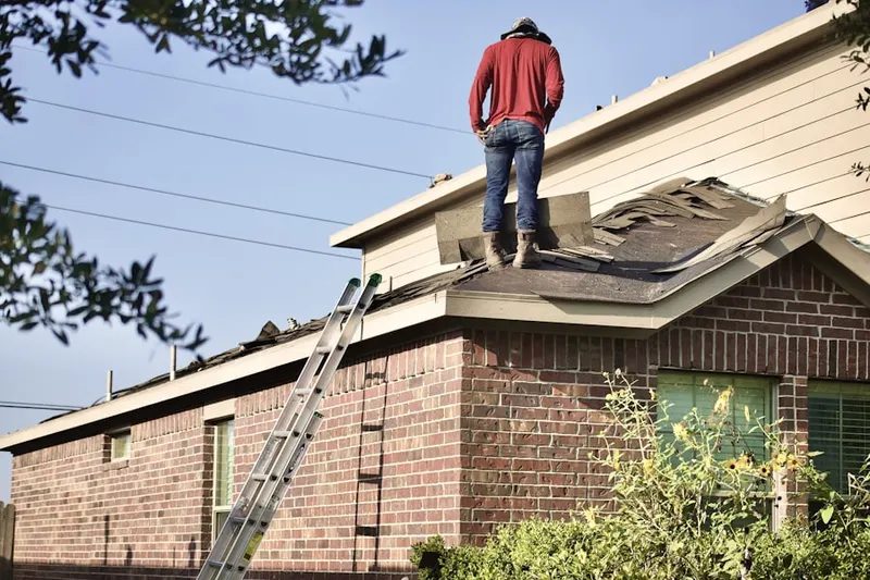 Professional roofer working on a residential roof in Camp Swift